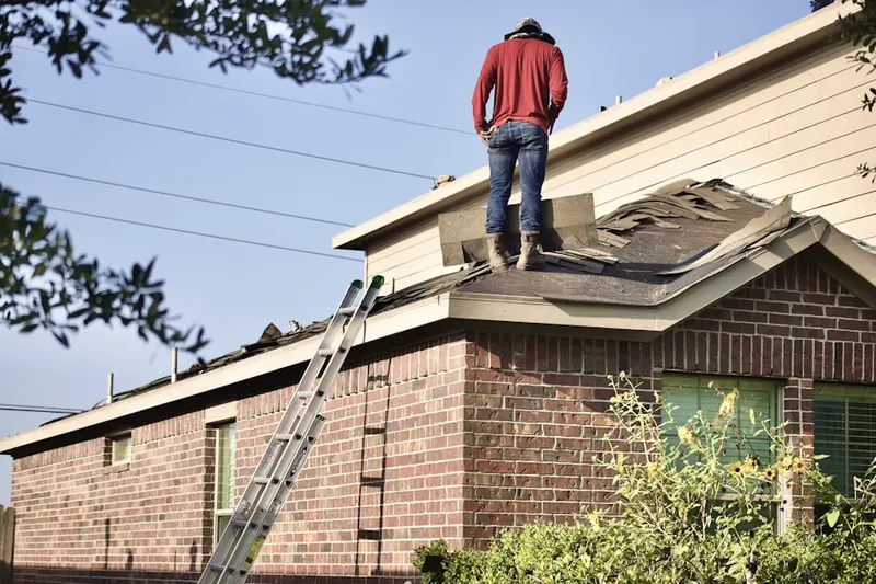 Professional roofer working on a residential roof in Immaculata